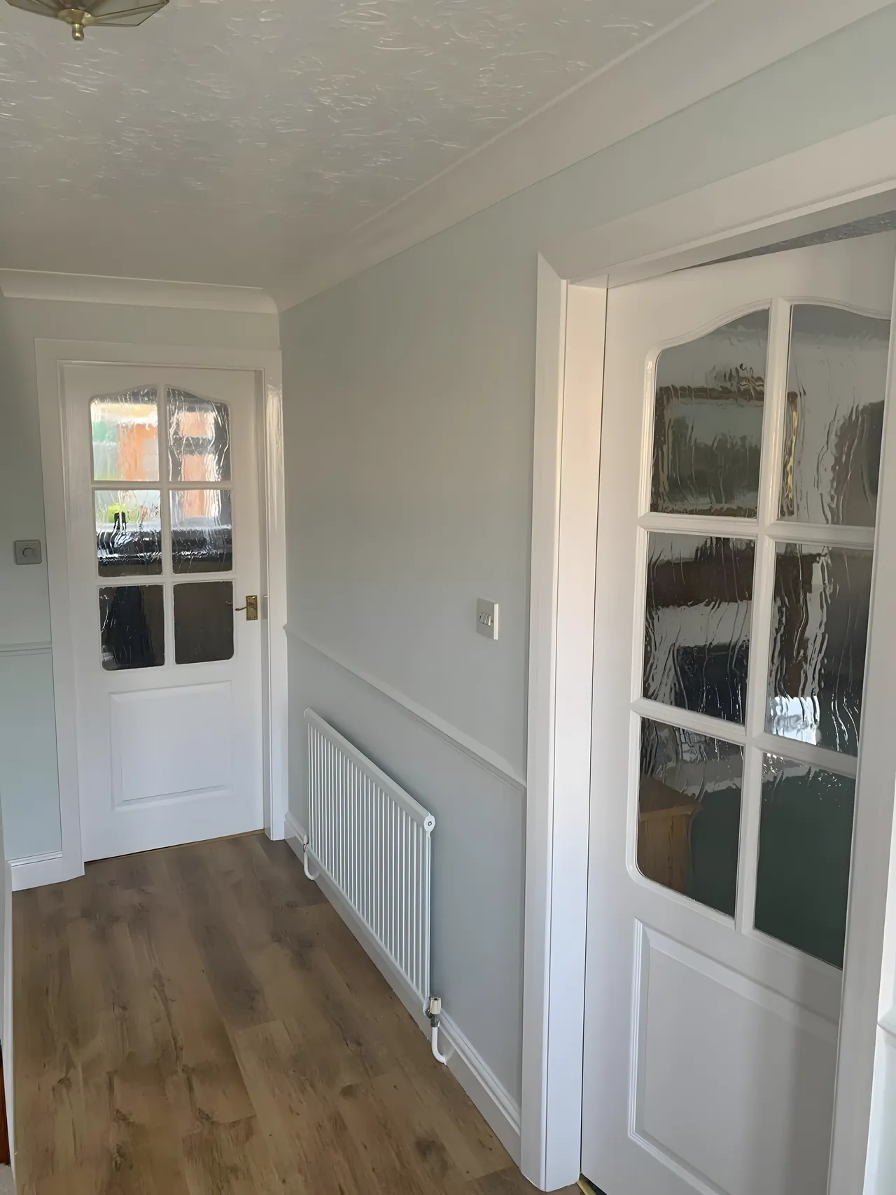 Rental property hallway with fresh walls, dado rail and white doors